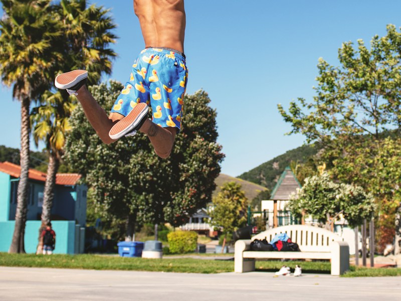 Basketball player jumping for a dunk outdoors