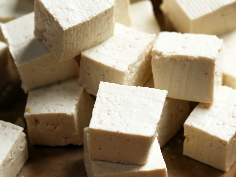 Cubes of calcium-set tofu on a cutting board