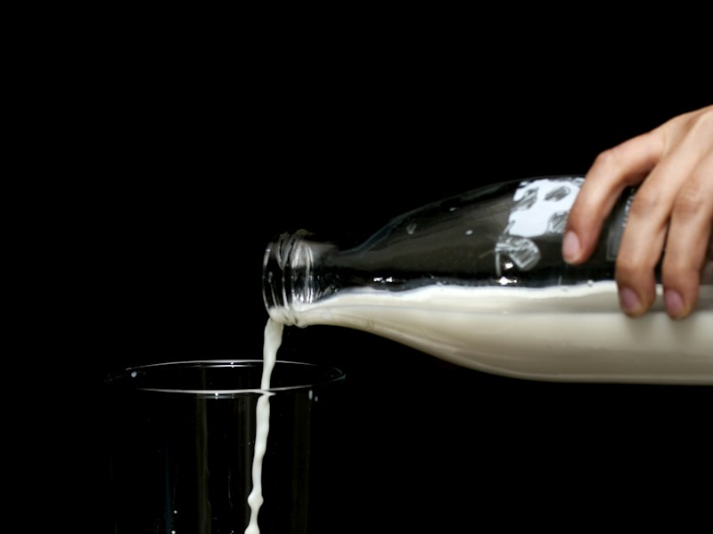 Pouring a glass of milk as a dietary calcium source