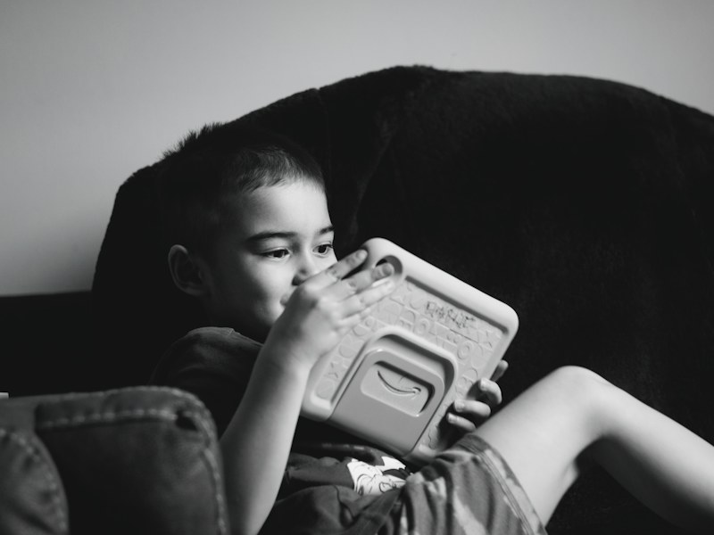 Young boy engrossed in a tablet device